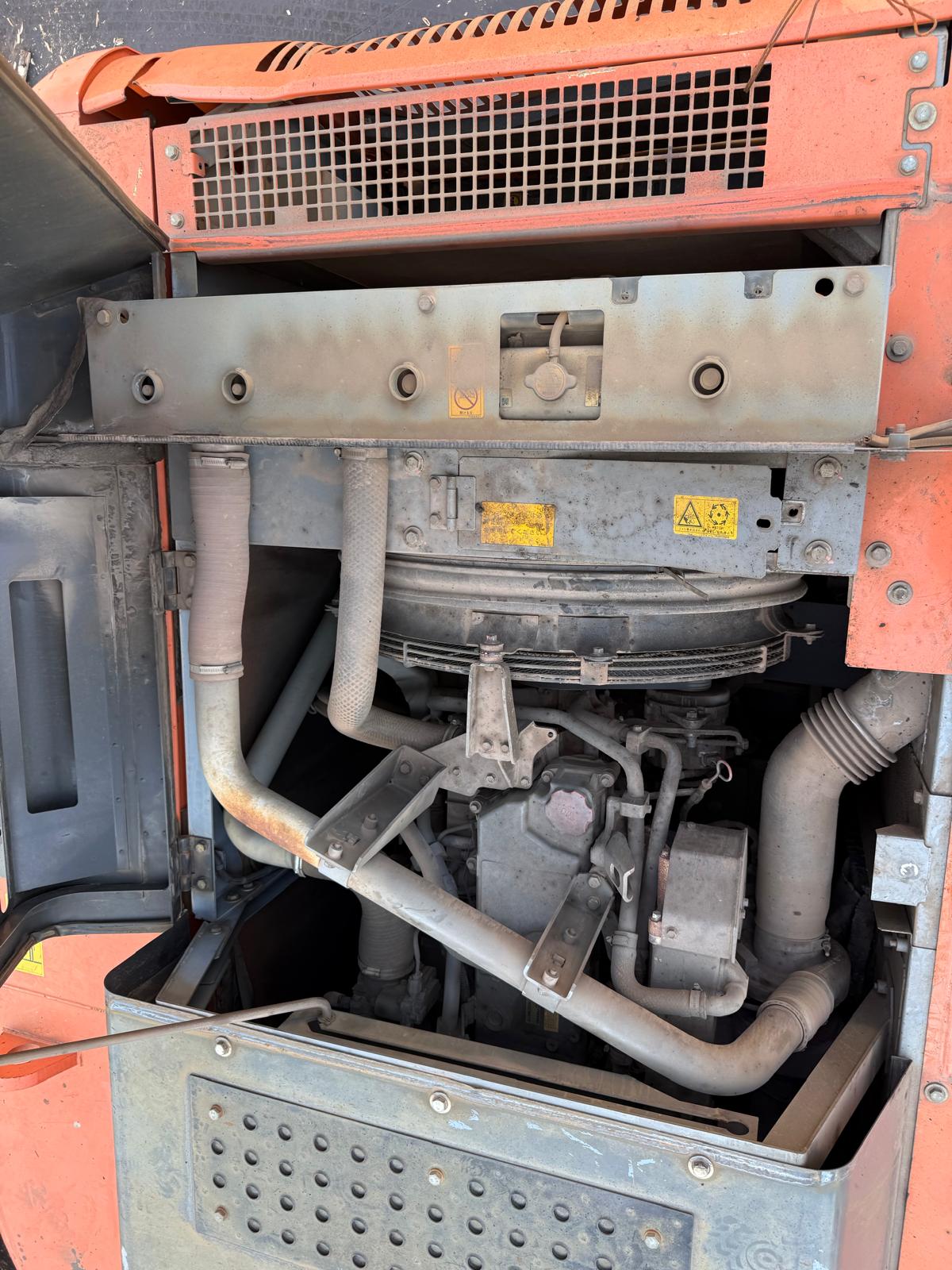 Engine compartment of a vehicle with visible components and wiring.