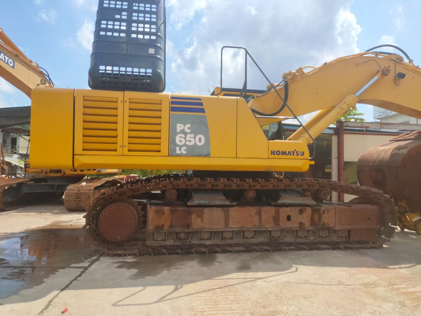Yellow excavator with 'Komatsu' branding on a concrete surface.