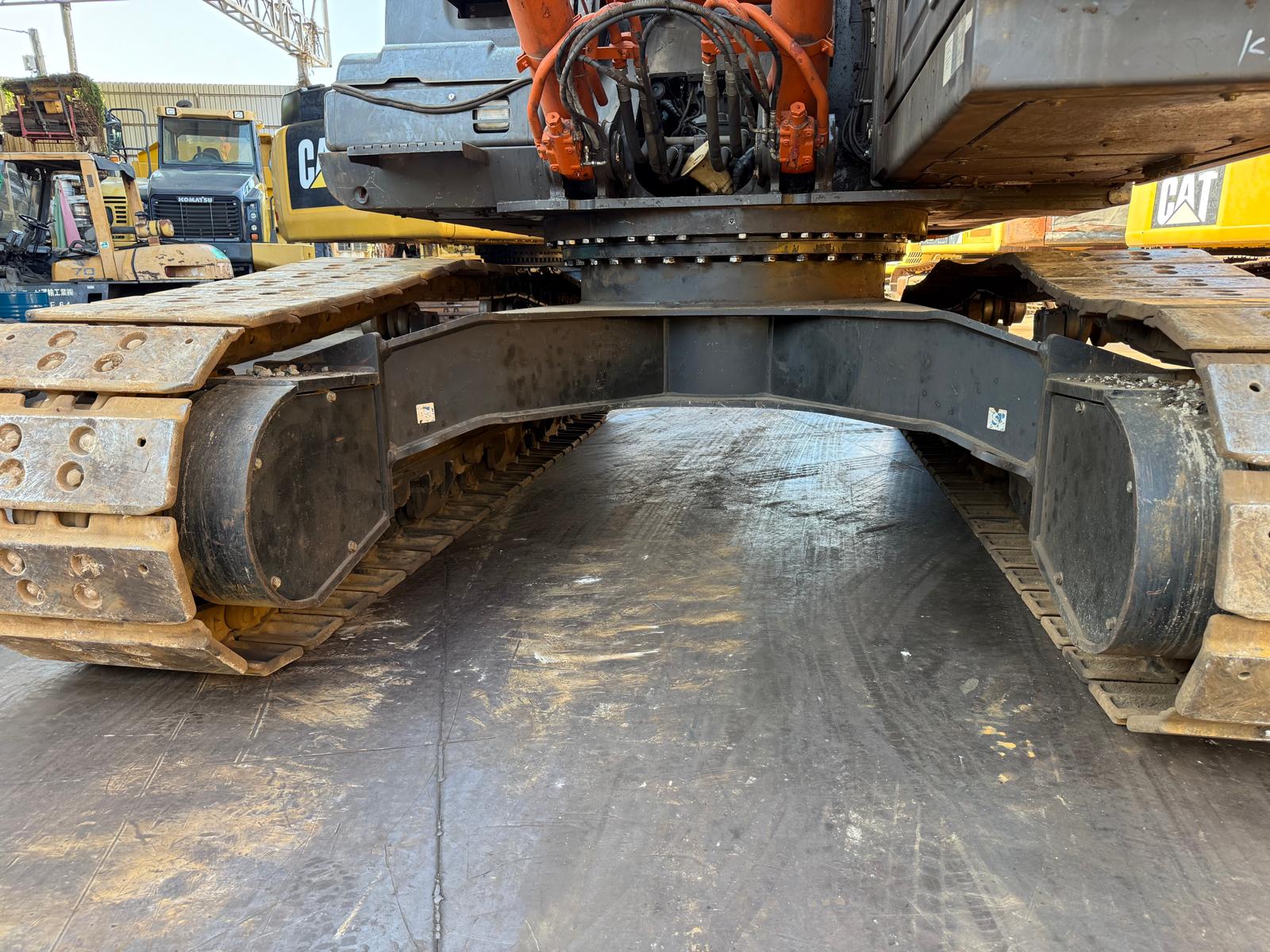 Close-up of a large construction vehicle's undercarriage with visible branding.